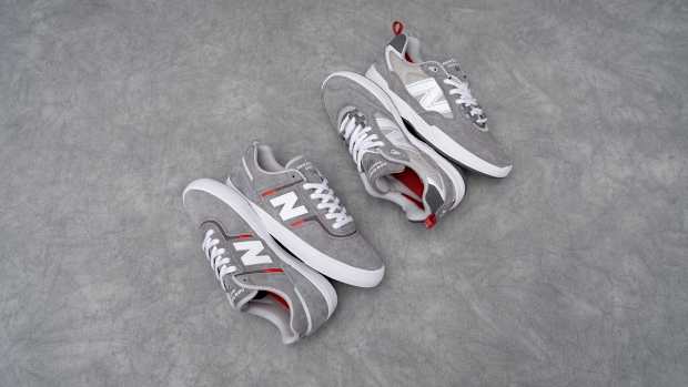 Side view of two grey New Balance shoes.